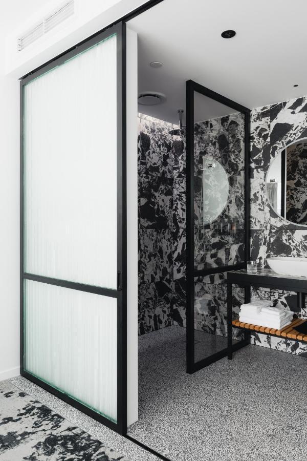 Ebb-Dunedin Eksteriør bilde A shower enclosure with a frosted glass door